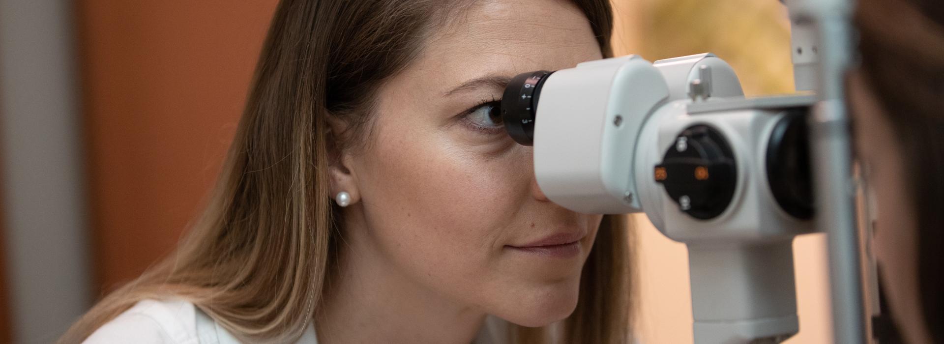 SCCO optometry student performing eye exam